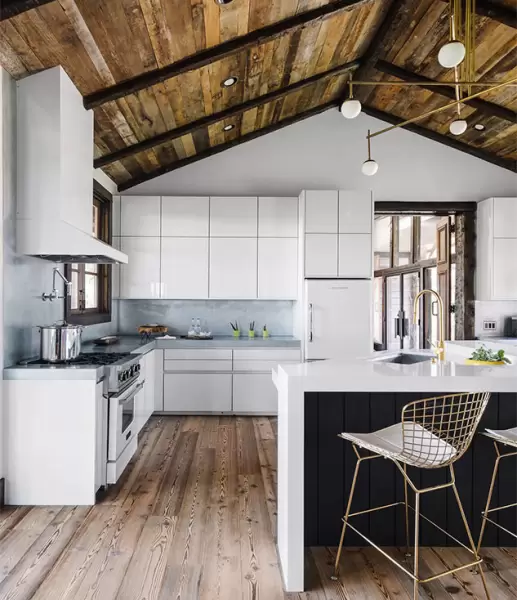 Modern kitchen with exposed ceiling and white cabinetry